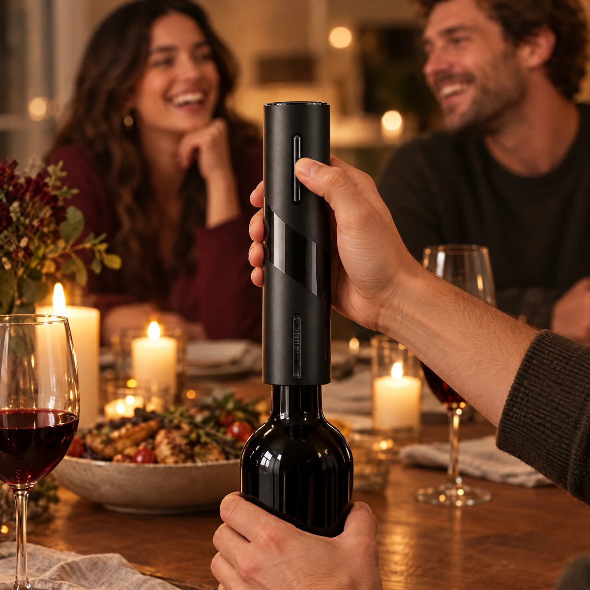 Opening a bottle of red wine with the electric wine opener at a dinner with friends